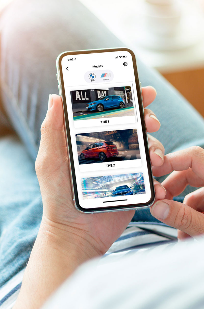 BMW Performance SG Mobile App - Man holding a phone using BMW Performance SG mobile application