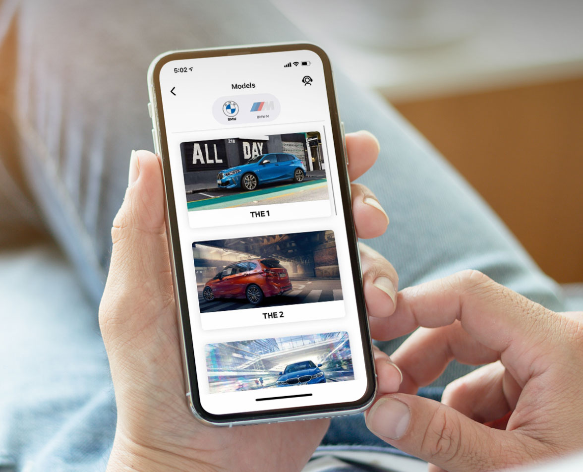 BMW Performance SG Mobile App - Man holding a phone using BMW Performance SG mobile application