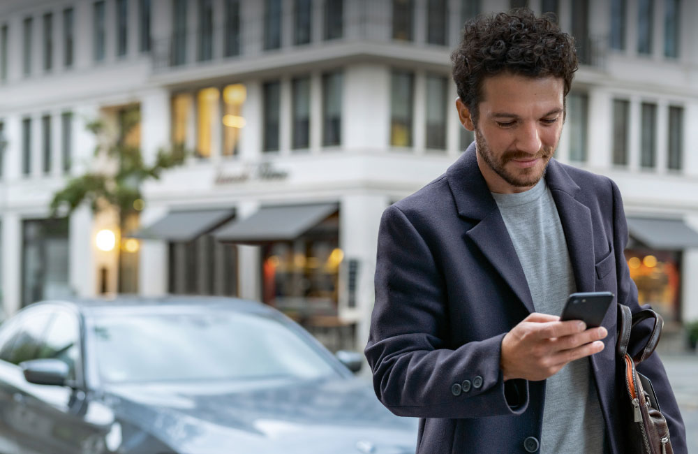 Man browsing BMW Convenience 360 on mobile phone