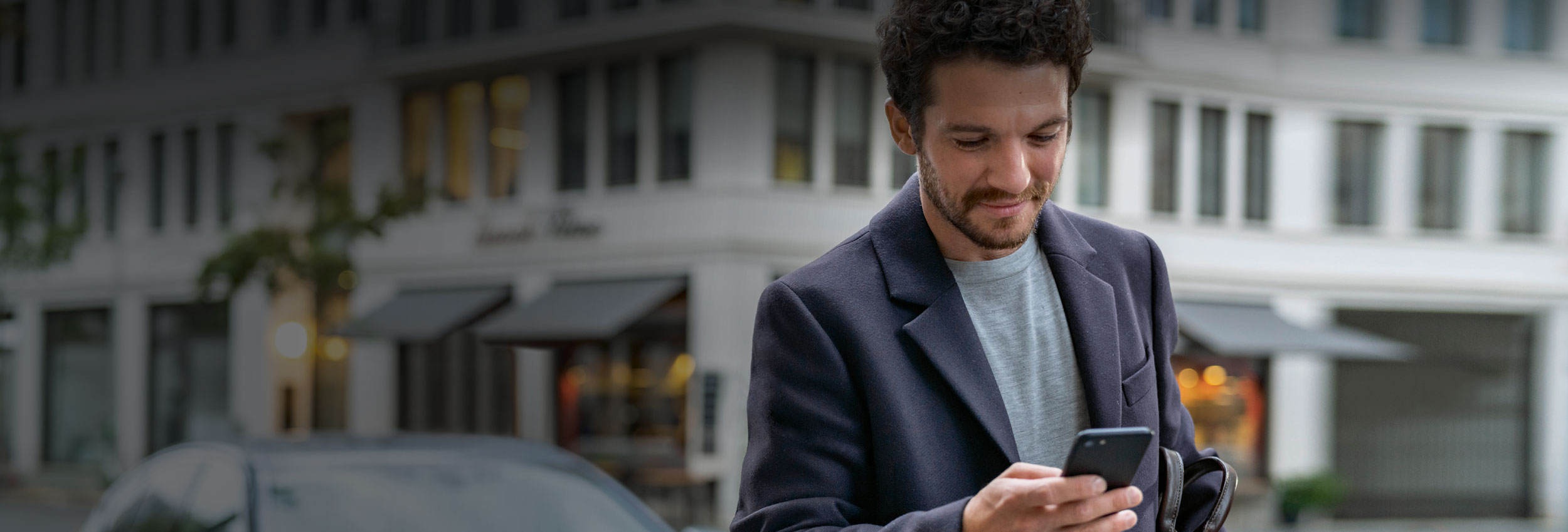 Man browsing BMW Convenience 360 on mobile phone